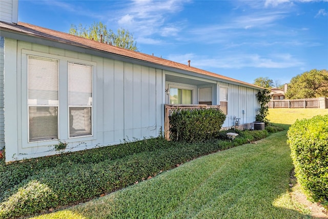 view of home's exterior featuring central AC and a yard