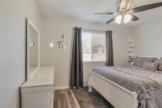 bedroom with hardwood / wood-style floors and ceiling fan