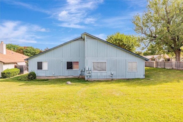 rear view of house featuring a yard