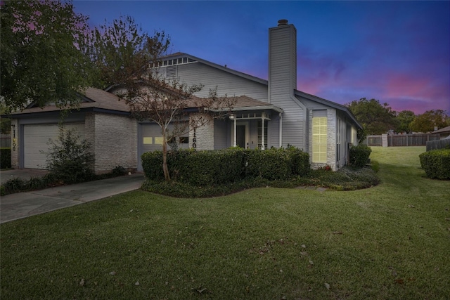 view of front facade featuring a garage and a lawn