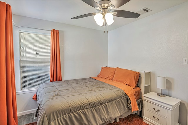 bedroom with hardwood / wood-style floors and ceiling fan