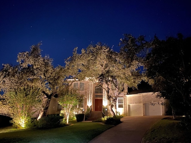 view of front of property with a garage and a yard