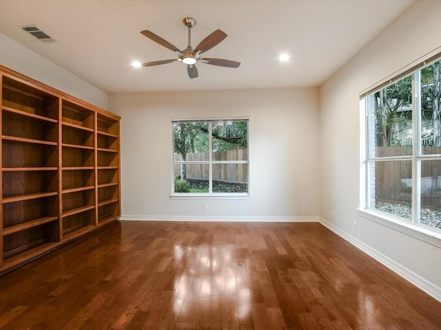 unfurnished room featuring ceiling fan and dark hardwood / wood-style flooring