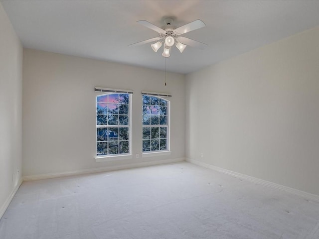 spare room with light carpet and ceiling fan