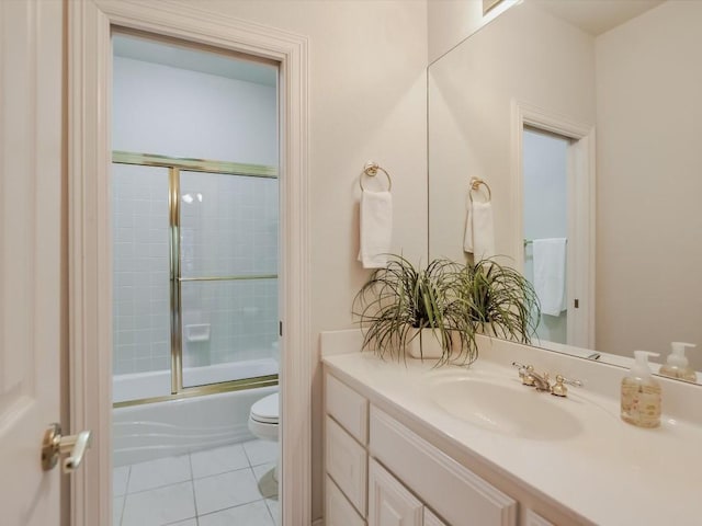 full bathroom with vanity, tile patterned floors, shower / bath combination with glass door, and toilet