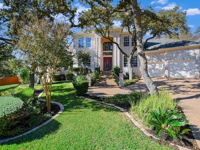 view of front of property featuring a garage and a front lawn