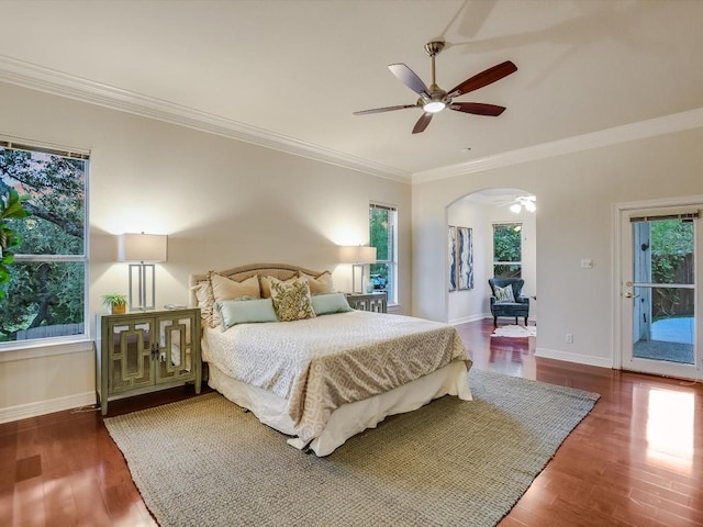 bedroom featuring crown molding, wood-type flooring, and multiple windows