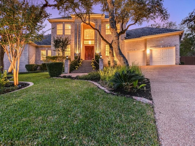 view of property with a yard and a garage