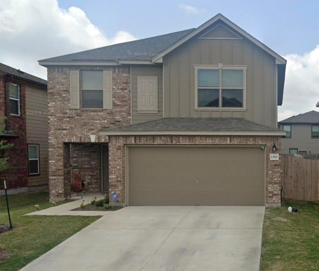 view of front of house with a garage and a front yard