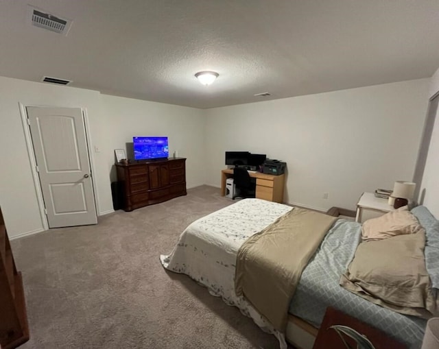 carpeted bedroom with a textured ceiling