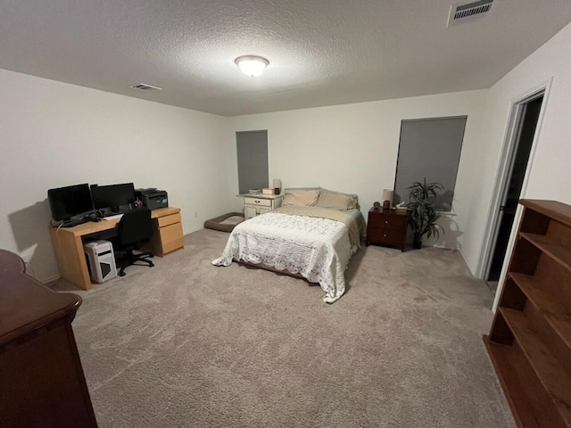 carpeted bedroom with a textured ceiling