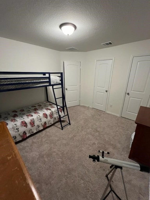 carpeted bedroom with a textured ceiling