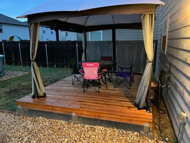 wooden terrace featuring a gazebo