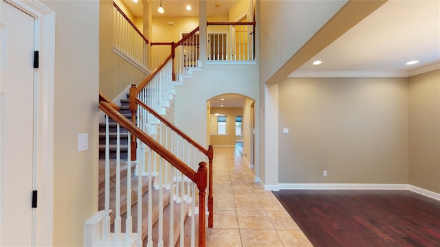 foyer featuring ornamental molding and light wood-type flooring