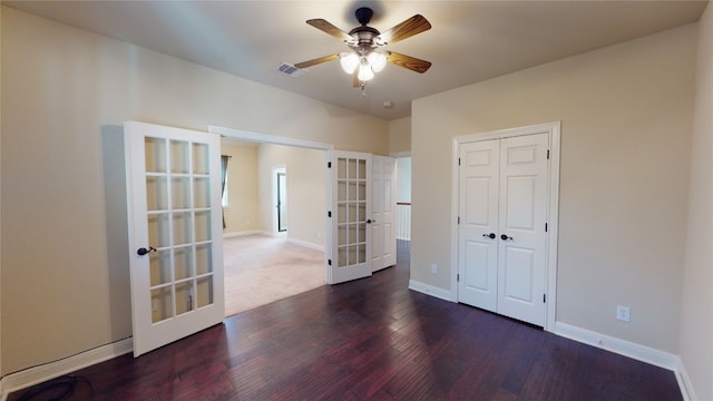 unfurnished room featuring dark hardwood / wood-style floors, ceiling fan, and french doors