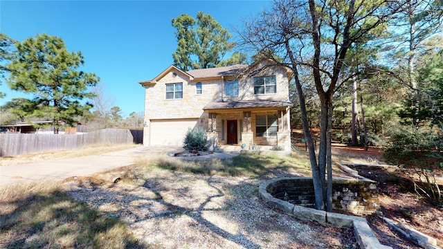 view of front of home featuring covered porch and a garage