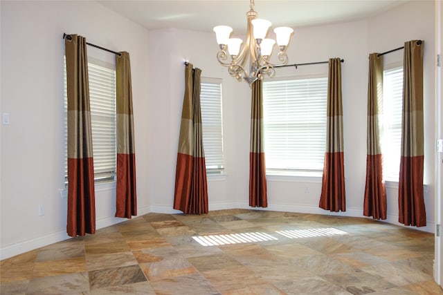 spare room featuring an inviting chandelier