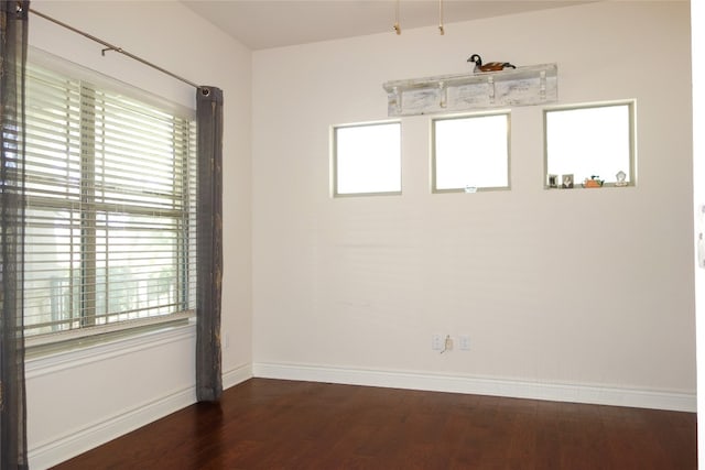 spare room with dark hardwood / wood-style flooring