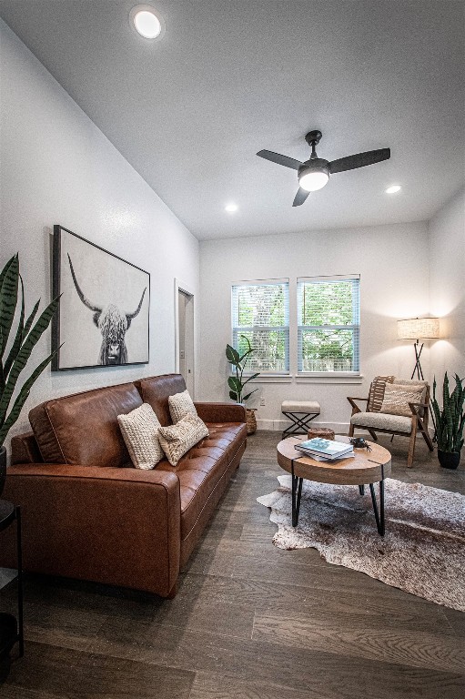 living room featuring a textured ceiling, dark hardwood / wood-style flooring, and ceiling fan