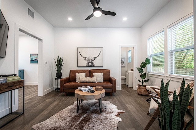 living area with dark hardwood / wood-style flooring and ceiling fan