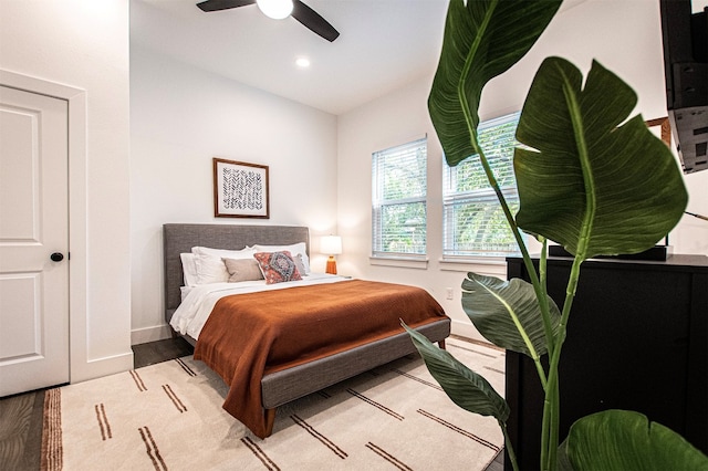 bedroom with ceiling fan and light wood-type flooring