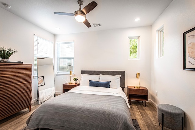 bedroom featuring multiple windows, ceiling fan, and hardwood / wood-style floors