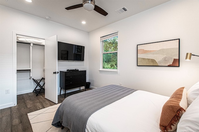 bedroom with ceiling fan, dark wood-type flooring, and a closet