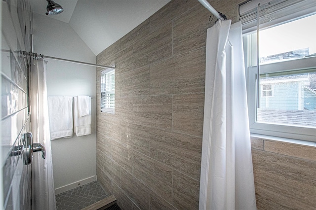 bathroom featuring a shower with shower curtain and lofted ceiling