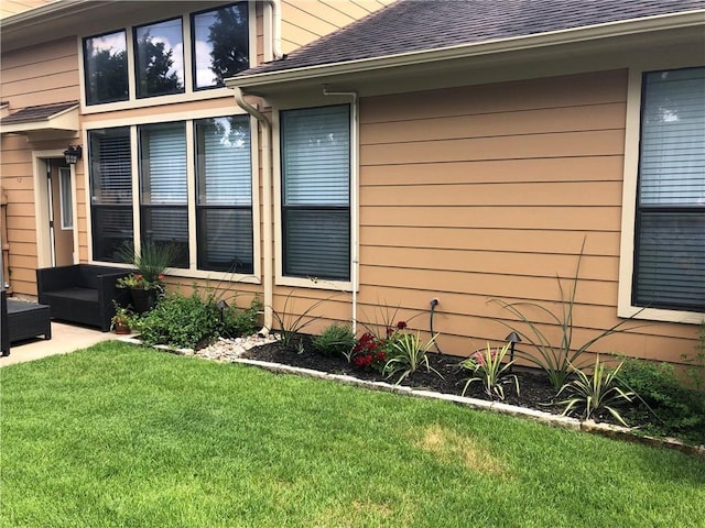 view of side of home with a lawn