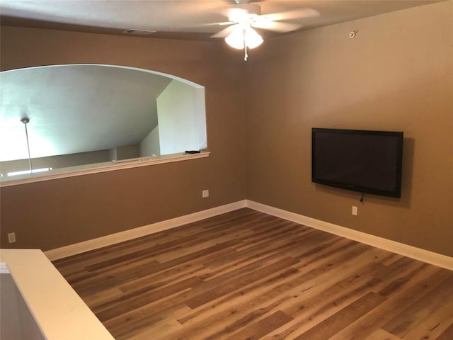 empty room with hardwood / wood-style flooring and ceiling fan