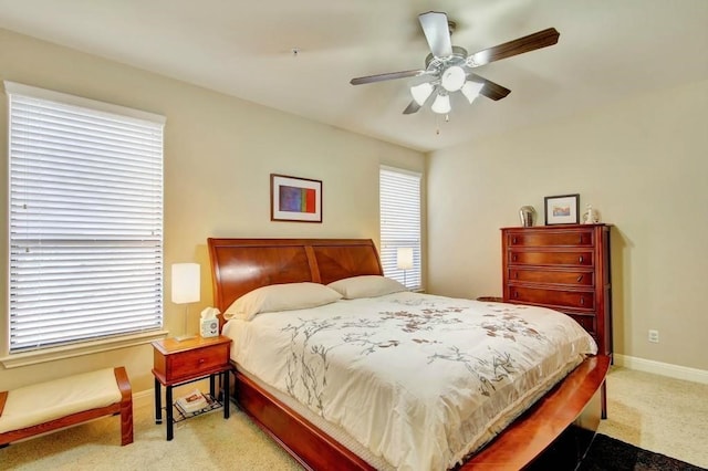 carpeted bedroom with multiple windows and ceiling fan