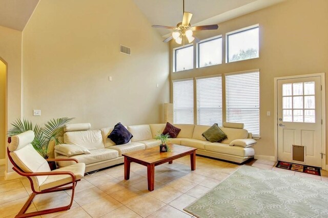 tiled living room with high vaulted ceiling and ceiling fan