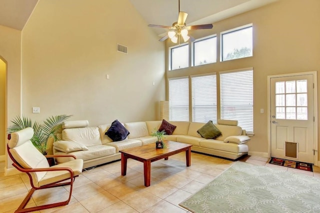 living room with ceiling fan, a healthy amount of sunlight, high vaulted ceiling, and light tile patterned floors