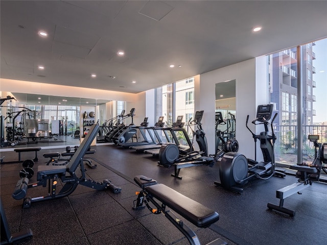 gym with a wall of windows, plenty of natural light, and recessed lighting