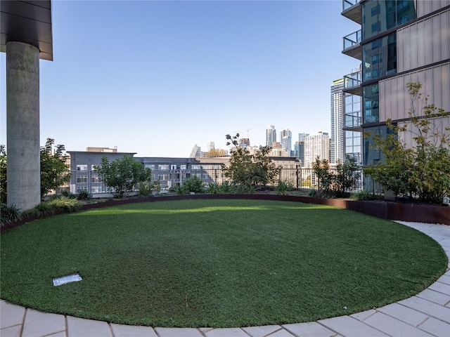 view of community with a view of city and a lawn