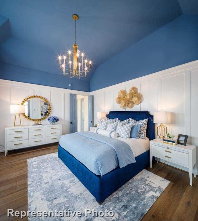 bedroom featuring dark wood-type flooring, an inviting chandelier, and lofted ceiling