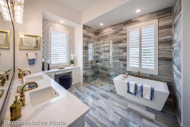 bathroom with plus walk in shower, vanity, plenty of natural light, and tile walls