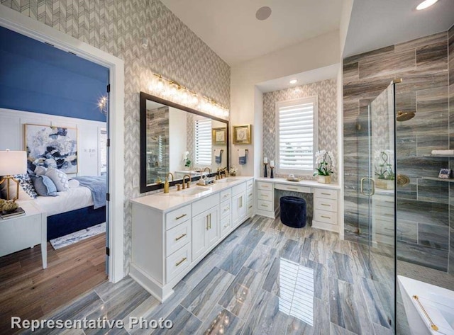 bathroom with walk in shower, vanity, and hardwood / wood-style flooring