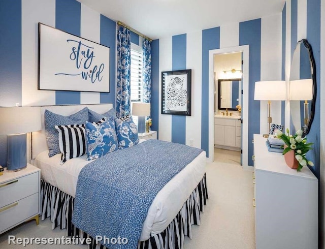 carpeted bedroom featuring ensuite bathroom