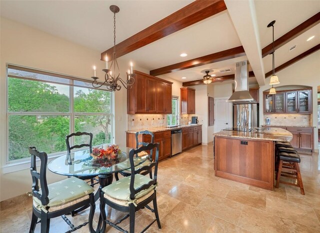 dining space featuring ceiling fan with notable chandelier and beam ceiling