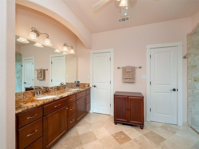 bathroom with vanity, ceiling fan, and walk in shower