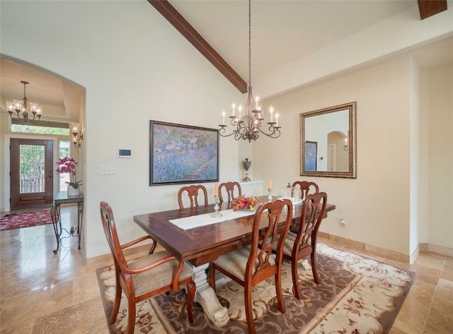 dining room with high vaulted ceiling and a chandelier