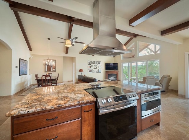 kitchen featuring light stone counters, island exhaust hood, appliances with stainless steel finishes, and beam ceiling