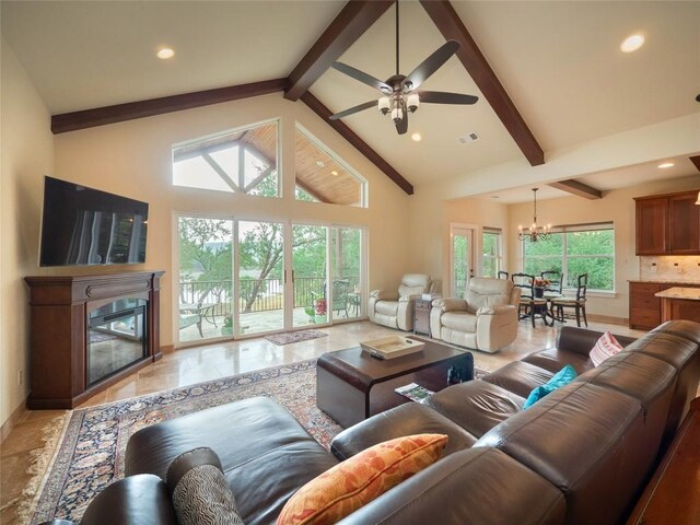 living room featuring beamed ceiling, ceiling fan with notable chandelier, and high vaulted ceiling