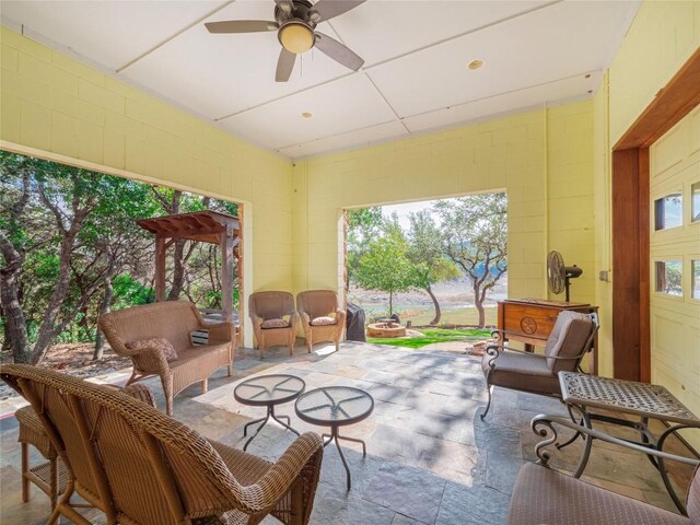 sunroom featuring ceiling fan and a healthy amount of sunlight