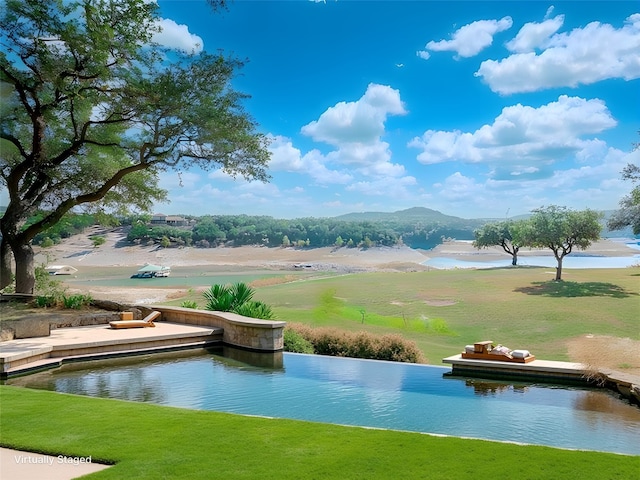 view of community with a water view and a yard