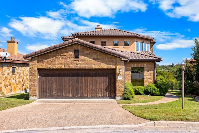 mediterranean / spanish-style home with a front lawn and a garage