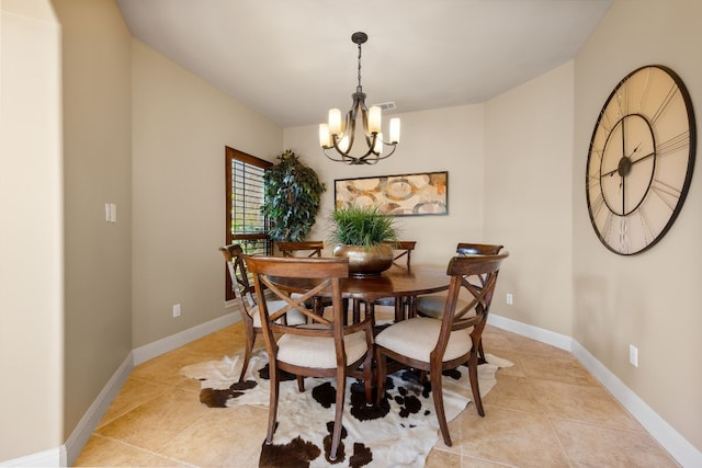 tiled dining room featuring a notable chandelier