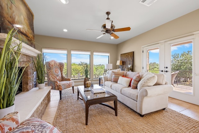 living room with ceiling fan, light tile patterned floors, a wealth of natural light, and french doors