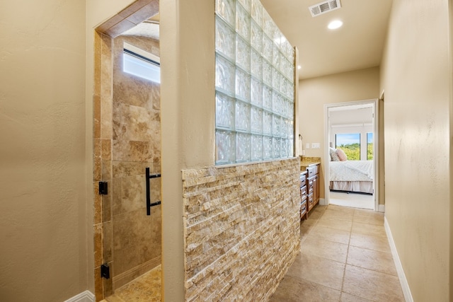 bathroom with tile patterned flooring, vanity, and an enclosed shower